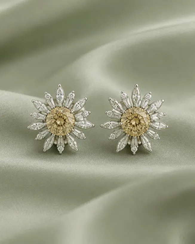 Puces d’oreilles en fleur, cœur doré, sur un satin vert sauge